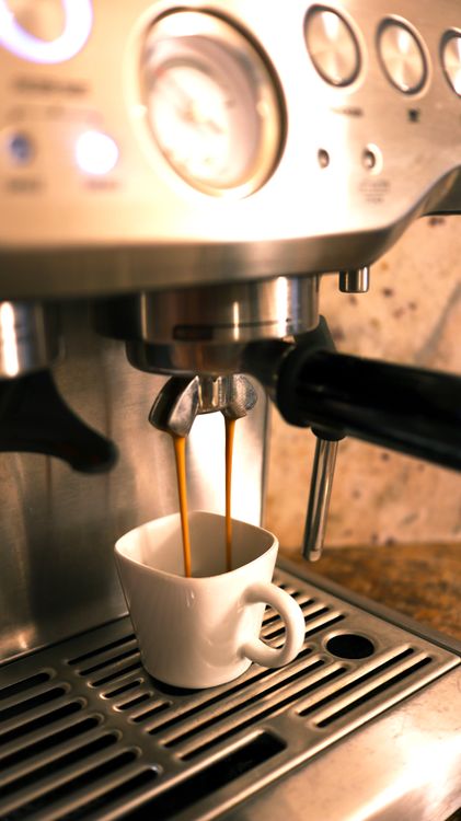 Espresso machine brewing a fresh shot into a white cup — best espresso machine under $200