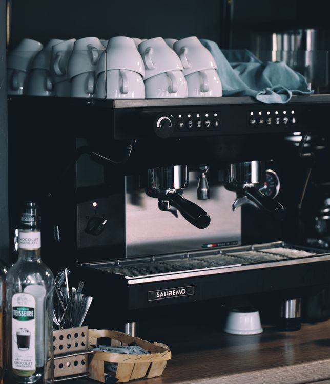 Professional espresso machine with white coffee cups