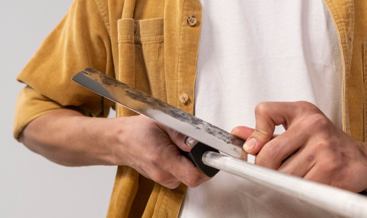 Sharpening a kitchen knife on a honing rod