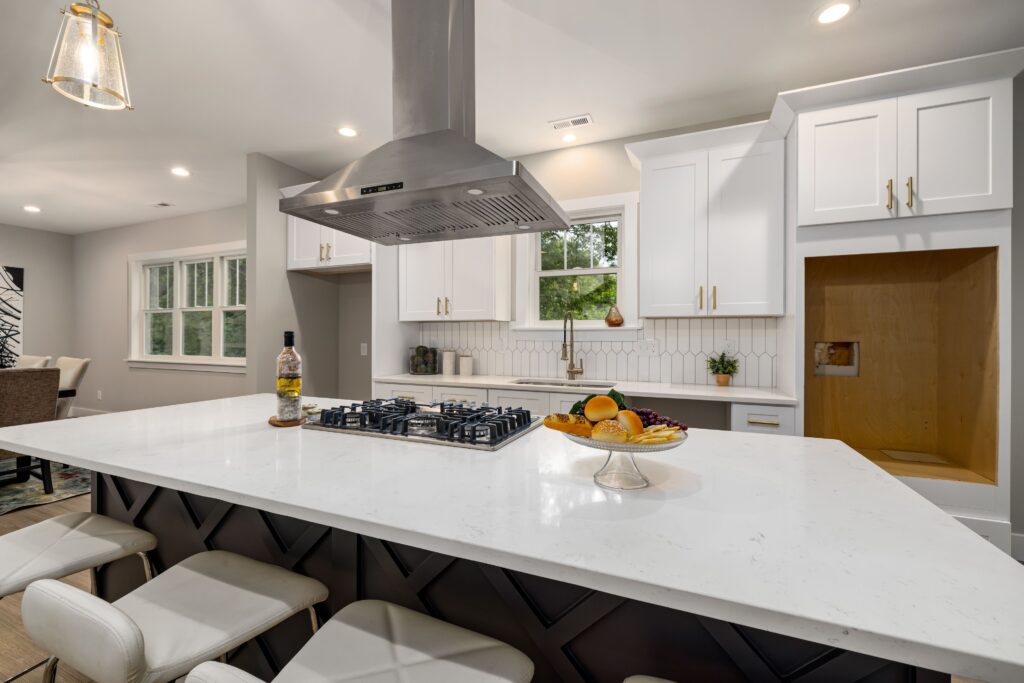 Kitchen with a stainless steel range hood installed above the cooktop