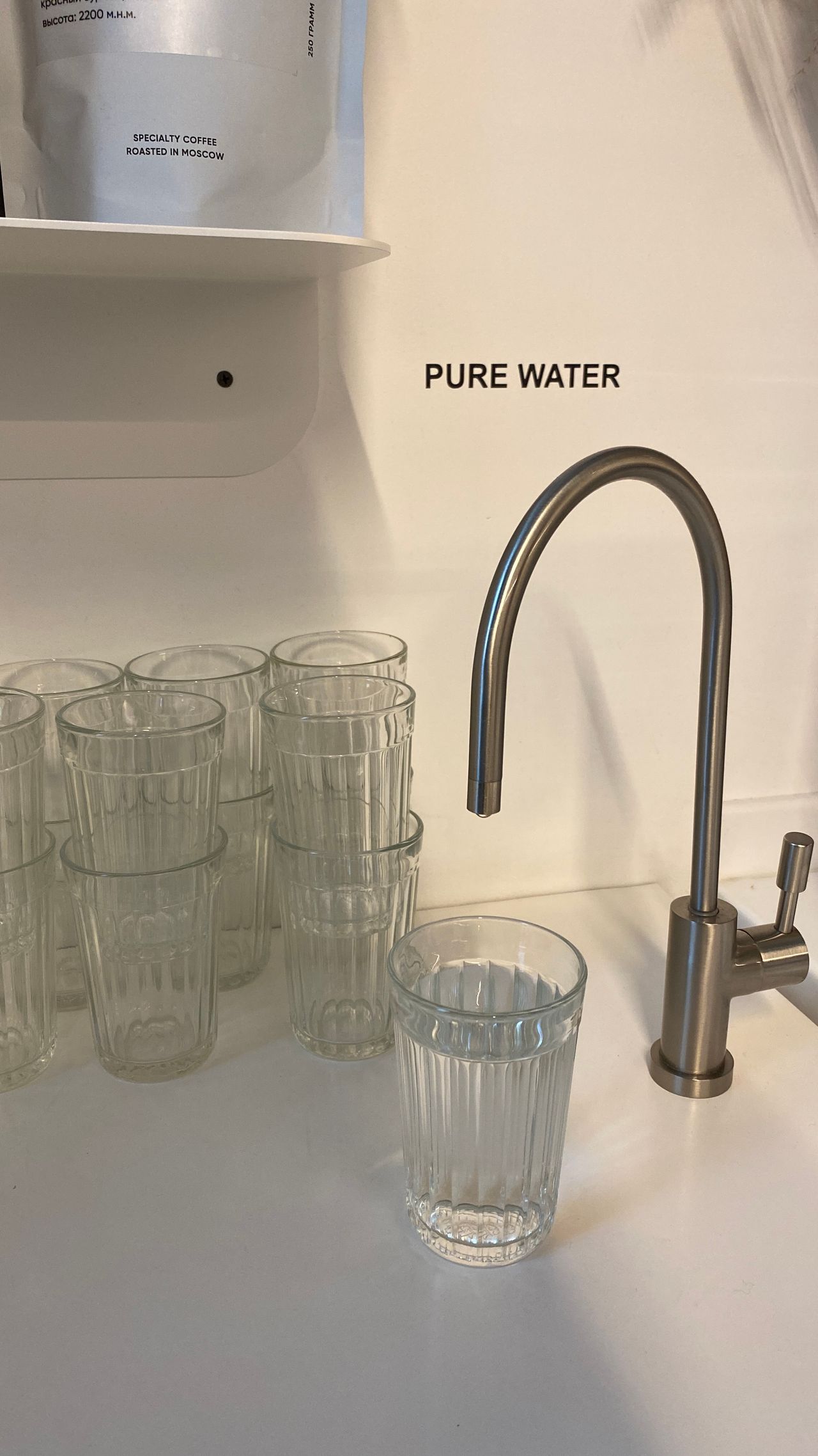 A pure water faucet filter filling glasses with filtered water