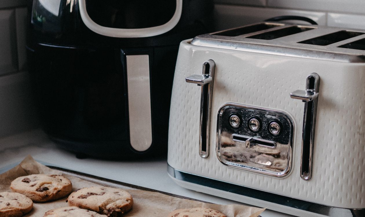 Air fryer on a kitchen counter next to a toaster