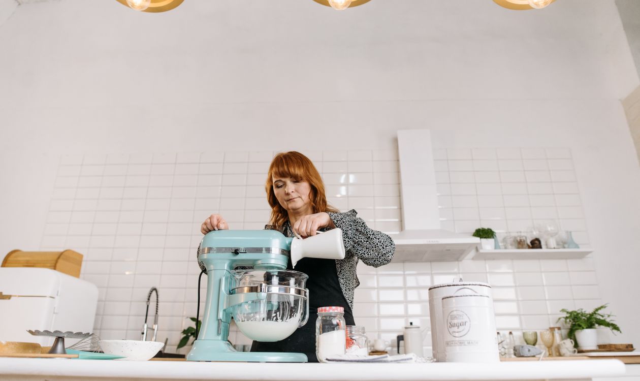 Woman using a KitchenAid stand mixer to bake