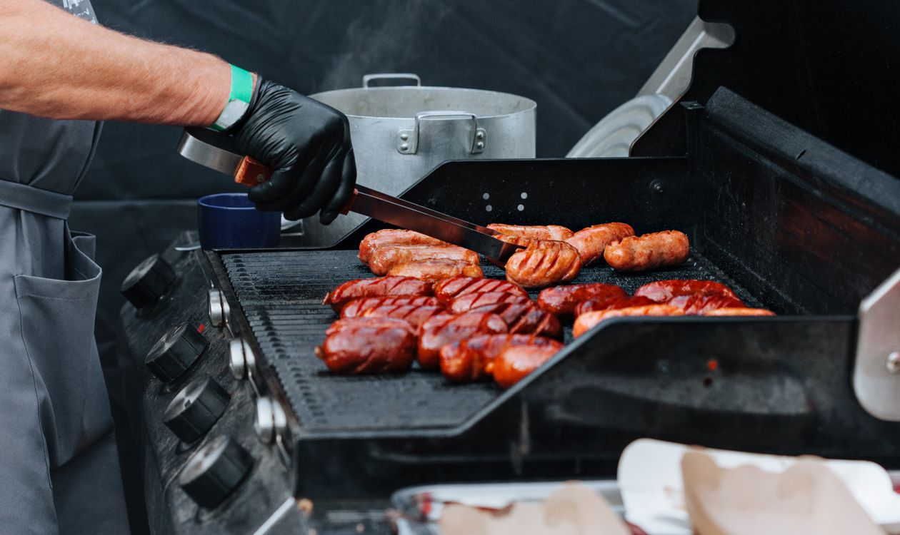 Grilling sausages on an outdoor barbecue