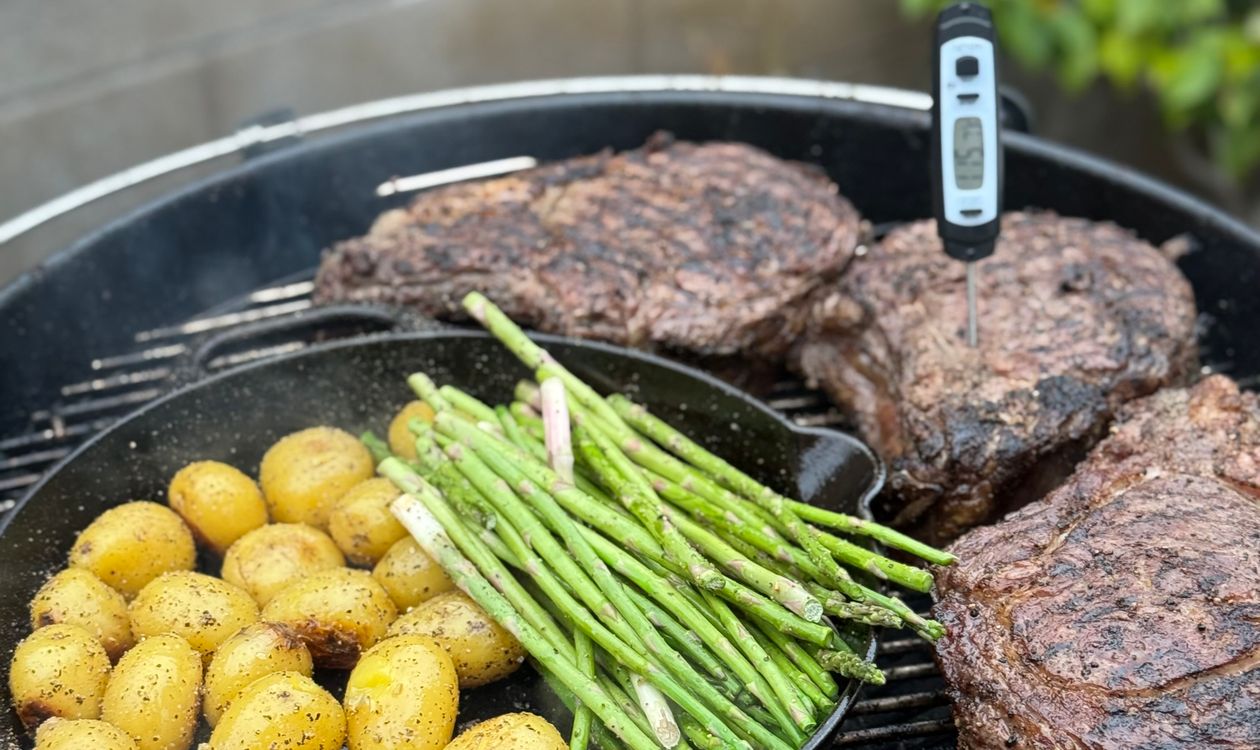 Ribeye steaks grilling outdoors