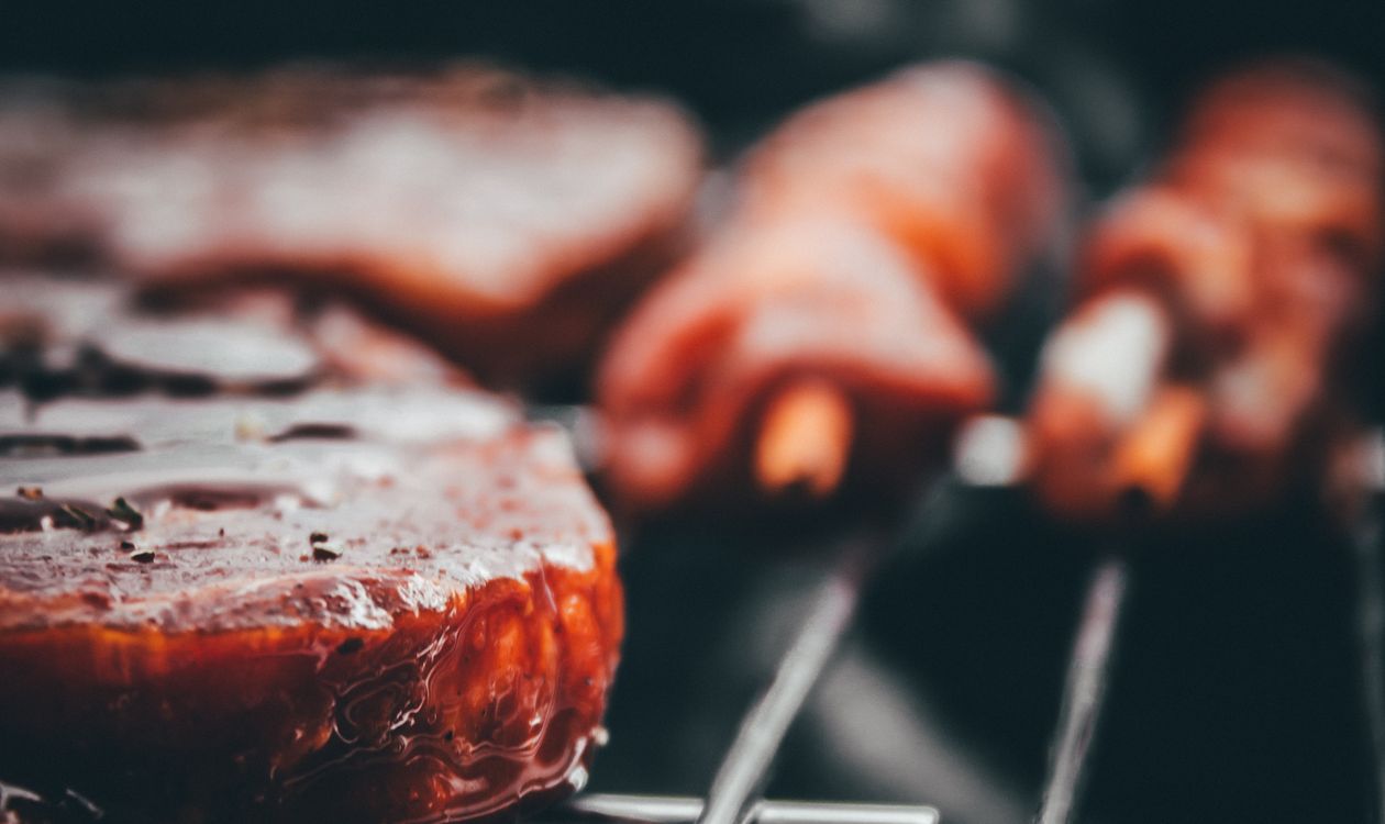Sizzling meat on a charcoal grill