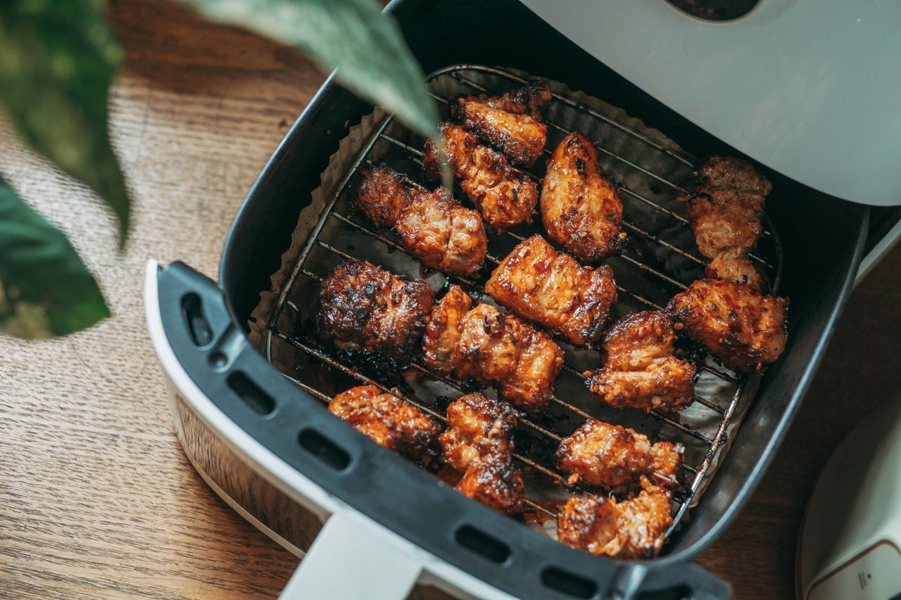 Crispy chicken pieces cooked in an air fryer basket