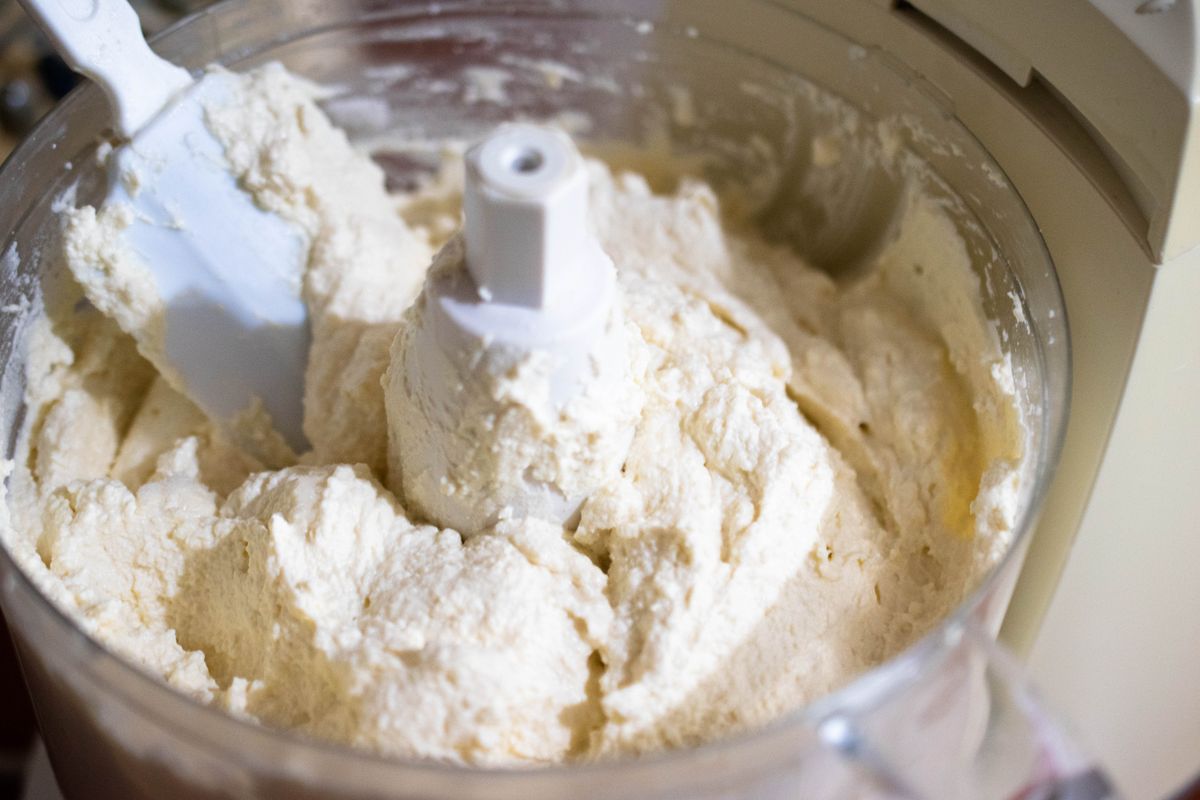 Cheese batter being mixed in a food processor bowl