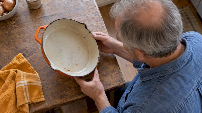 Cook inspecting chipped warped pan