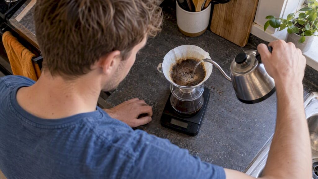 Water being weighed as it pours over coffee