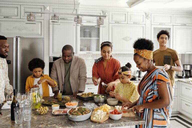 A family preparing a meal together around a kitchen island